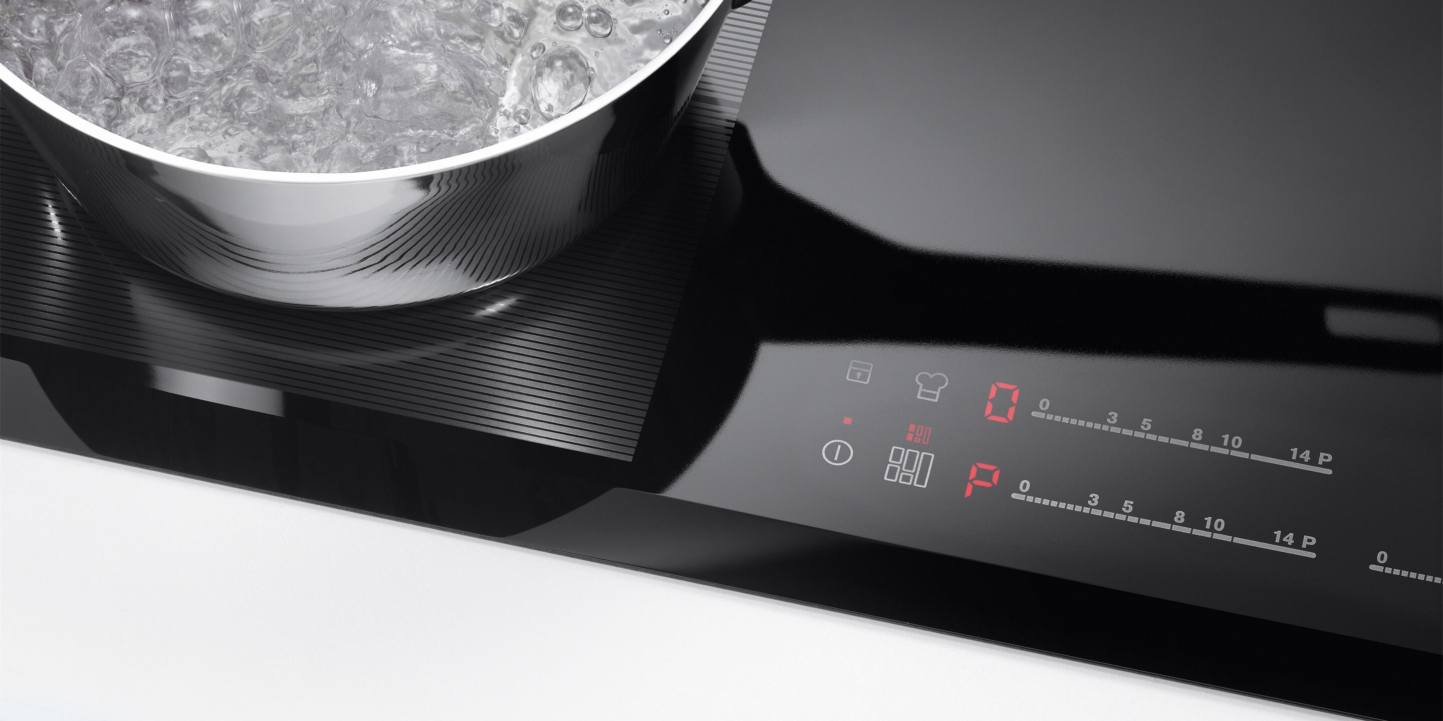 Tlačidlo spustiť a zastaviť na indukčnom paneli Electrolux