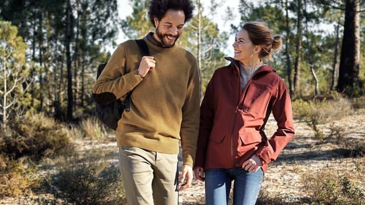 Two people walking in forest
